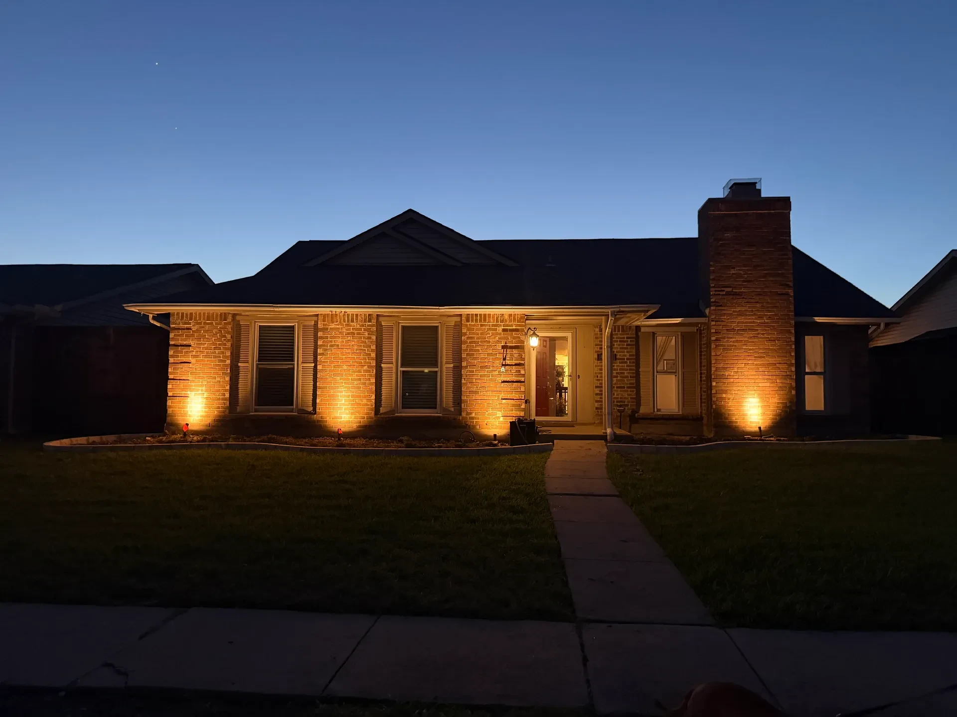 brick house facade lighting at dusk