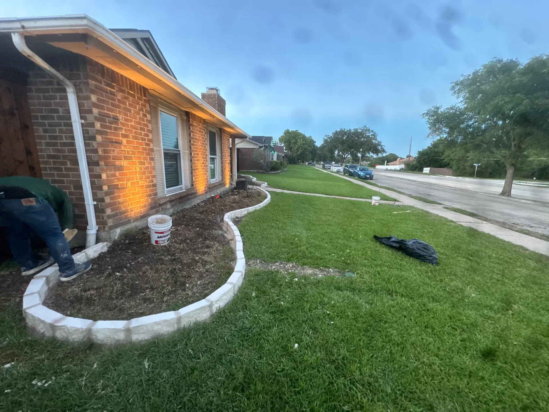 curved stone flower bed border and lawn