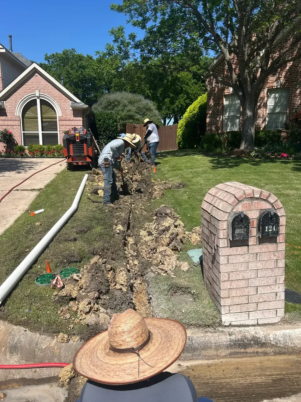 Drainage trench leading from the front yard toward the curb