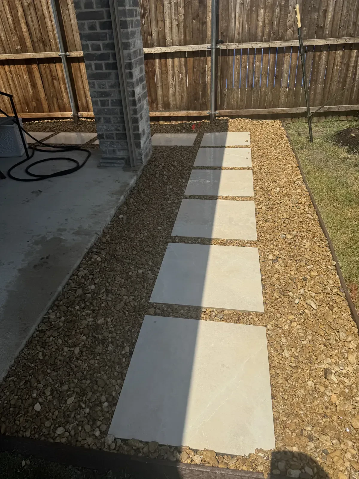 Golden gravel and stepping stones at patio entry