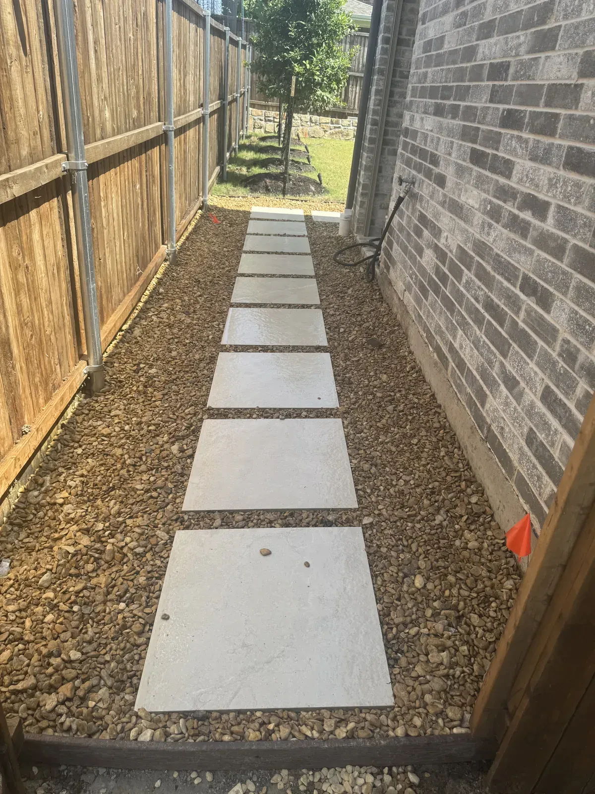 Completed narrow side yard gravel walkway