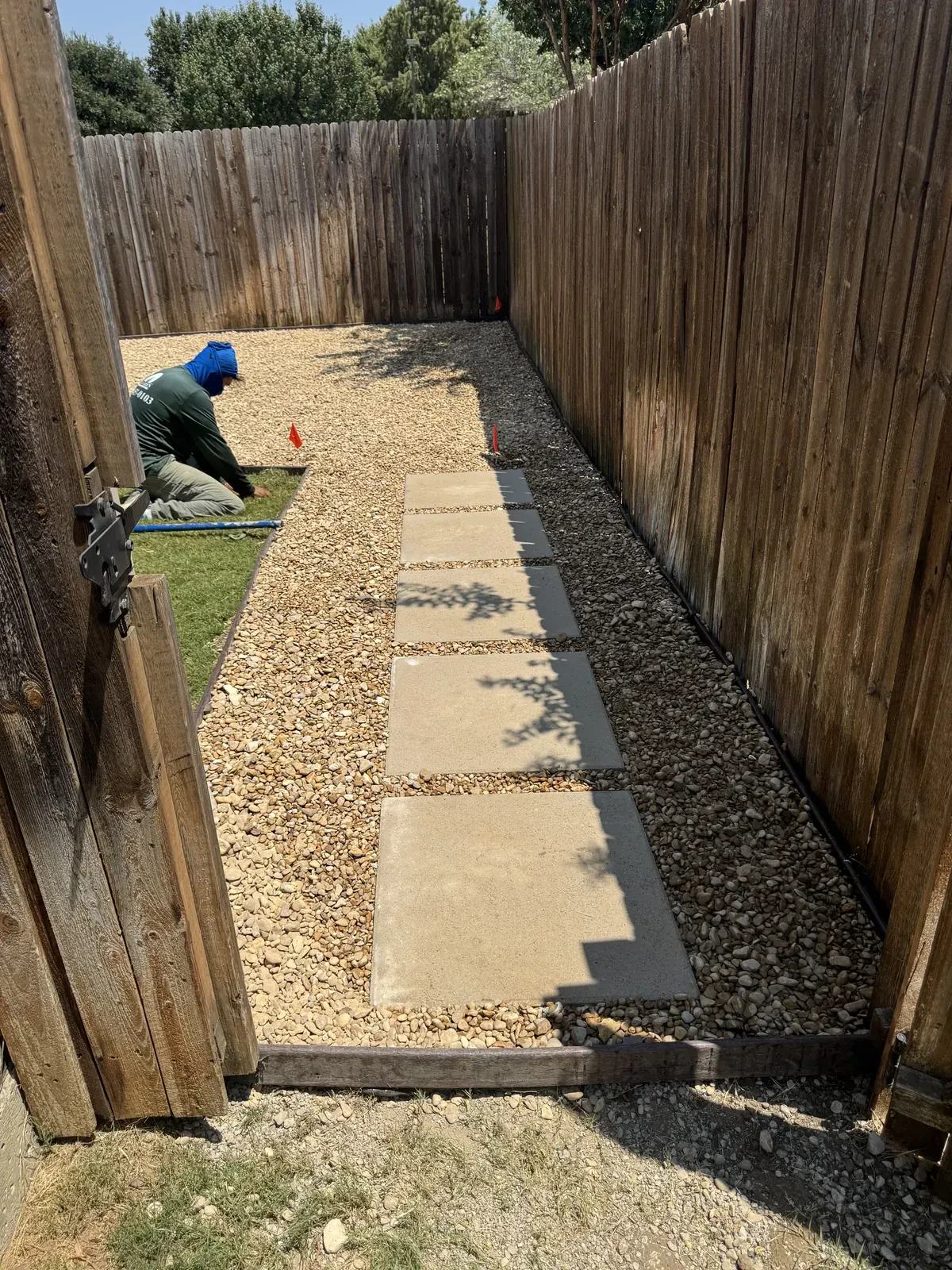 Crew finishing gravel around stepping stones