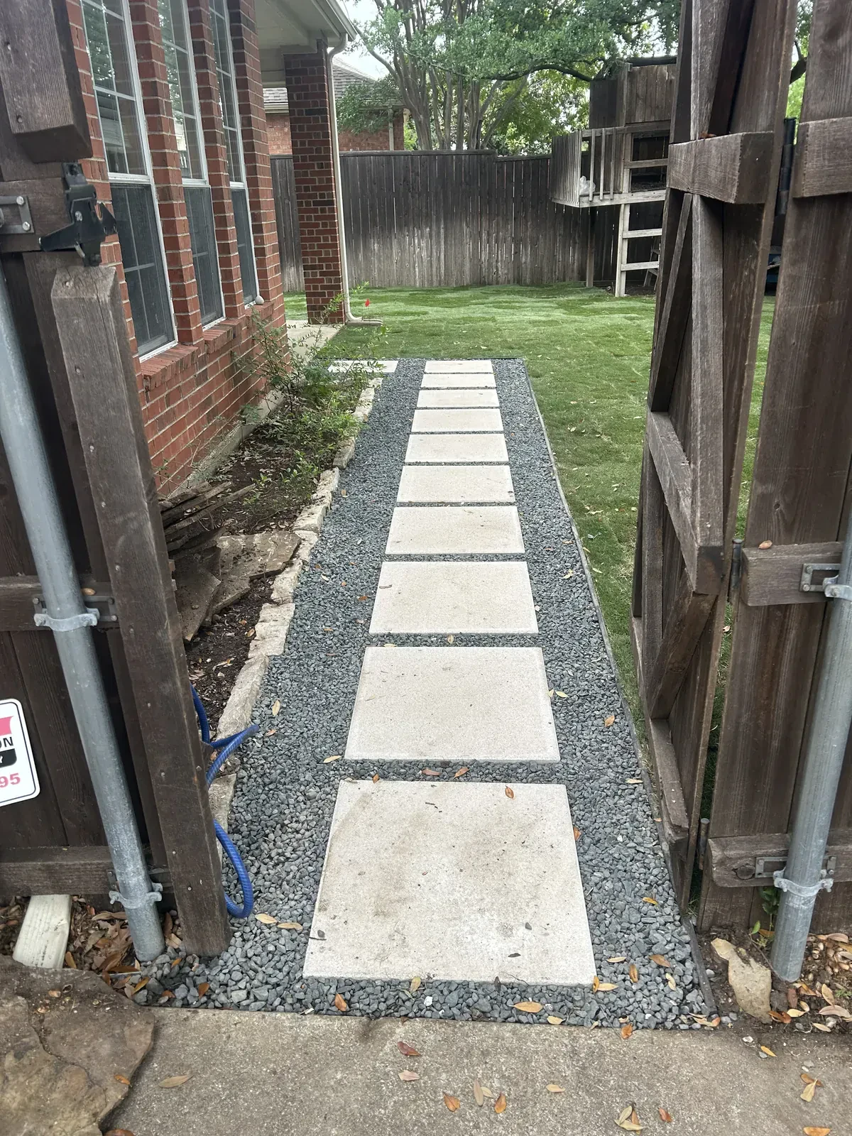 Completed concrete stepping stone path in charcoal gravel