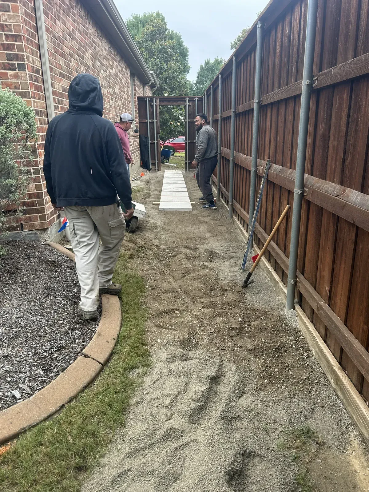 Crew grading a side yard walkway base
