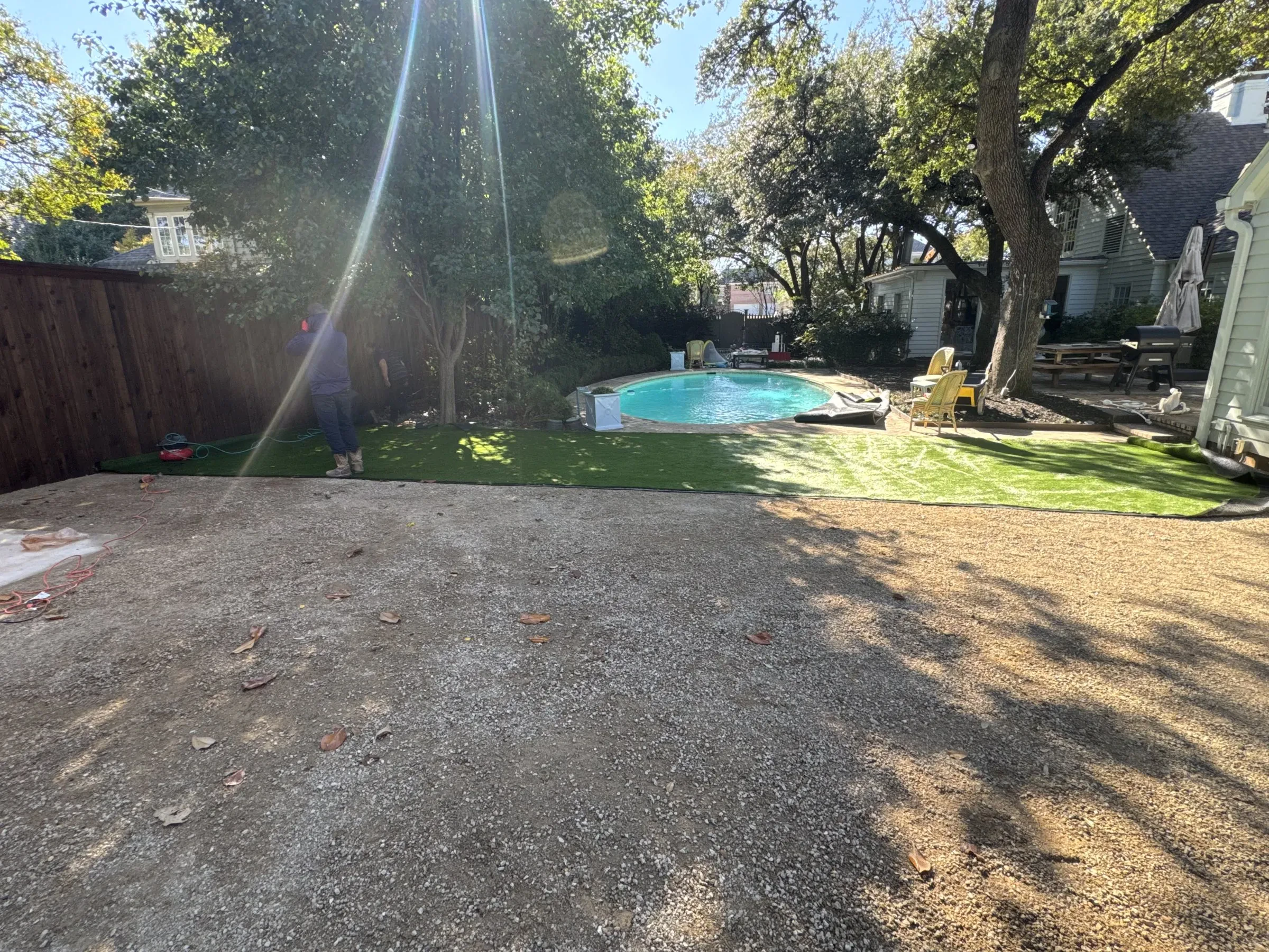 Prepared aggregate base before artificial turf is laid near a pool